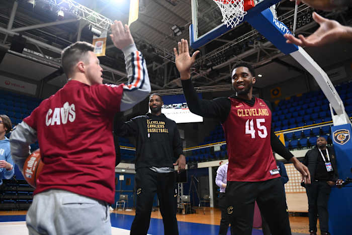 Cleveland Cavaliers guard Donovan Mitchell high-fives a participant at a Jr. NBA Camp in Paris, France.